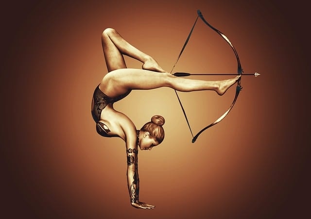 Girl doing handstand with bow and arrow